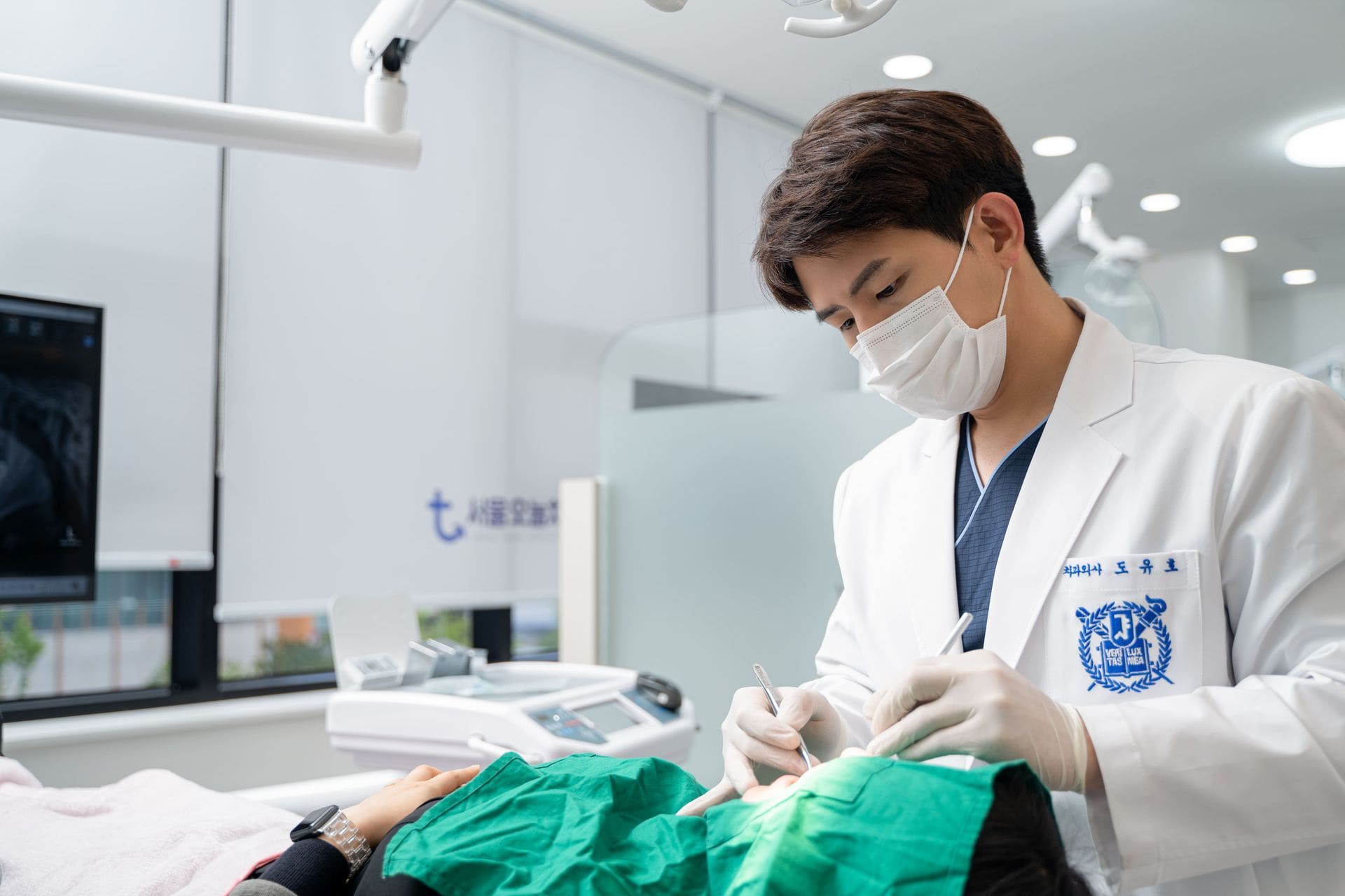 Dr. Doh performing dental treatment in a bright treatment room at Seoul Today Dental Clinic