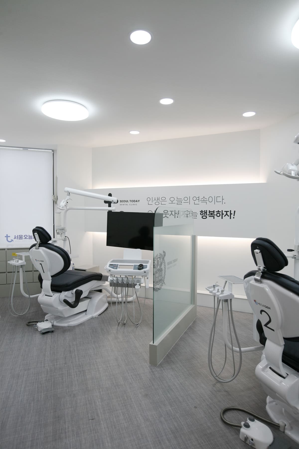Modern treatment room with dental chairs and the clinic's motto on the wall at Seoul Today Dental Clinic